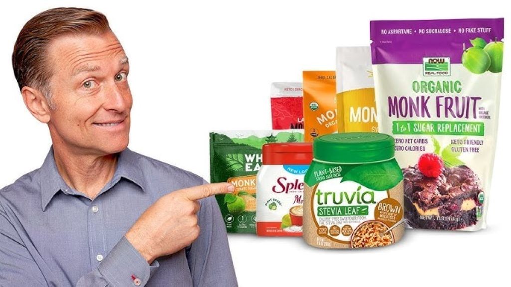 Close-up of monk fruit and stevia extract packets with baked goods in the background, highlighting sweetener choices